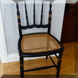 F21. Black painted caned side chair with stenciling. 34”h x 16”w x 15”d - $35 